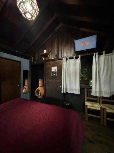 a bedroom with a red bed and a sign that reads infinity at Los Azufres Spa Natural in Los Azufres