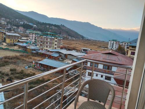 a balcony with a view of a city at Nirvana Inn in Paro