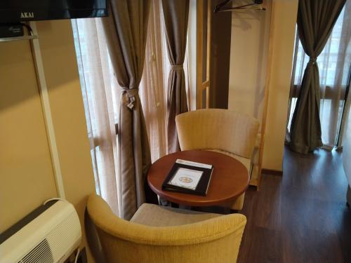 a room with a table and chairs and a window at Nirvana Inn in Paro