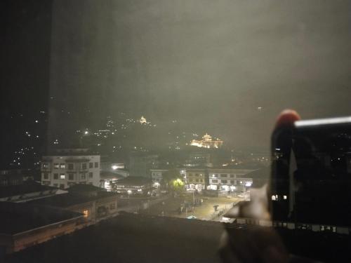 a view of a city at night at Nirvana Inn in Paro