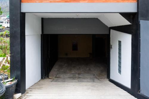 an open garage with the door open at RedDoorz Syariah near Gerbang Dieng 2 in Dieng