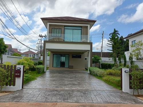 a house with a driveway in front of it at 88house suratthani in Suratthani