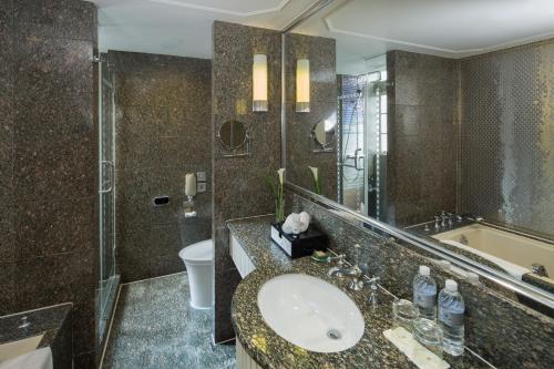 a bathroom with a sink and a shower and a toilet at Jin Jiang Hotel in Shanghai