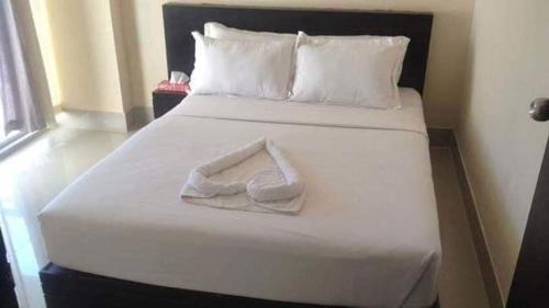 KelātaliにあるWorld Beach Resortの白いタオル(客室内のベッドに座る)