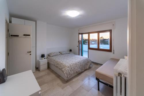 a bedroom with a bed and a window at Eur - Penthouse in Rome