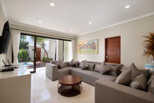 a living room with a couch and a table at Daha Mansions Seminyak in Seminyak