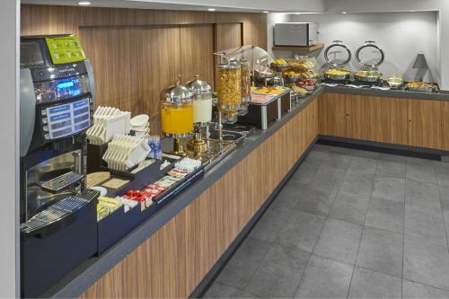 a buffet line in a restaurant with food and drinks at City Express by Marriott Tijuana Otay in Tijuana