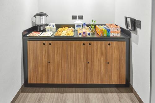 a counter with food and drinks on top of it at City Express by Marriott Tijuana Otay in Tijuana