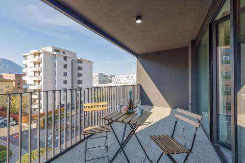 a balcony with two chairs and a table on it at ICON H - Luxury Business Suite & Apartments in Lugano