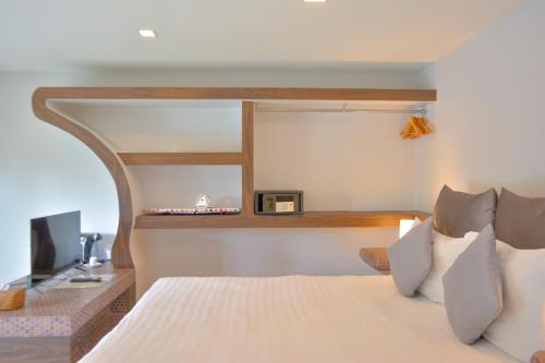 Ein Bett oder Betten in einem Zimmer der Unterkunft Le Divine Comedie Beach Resort