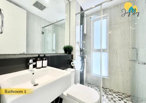 a bathroom with a white sink and a toilet at The Shore l 3BR l 6-11pax l 23A07 l Direct Access to Mall l JonkerSt l Melaka River View l City Centre by Jay Stay Management in Melaka