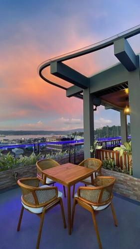 a table and chairs on a balcony with a view at Golden Palace Hotel in Batu Merah