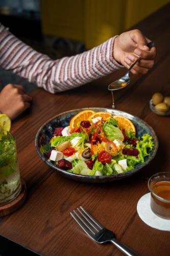 a person sitting at a table with a plate of food at La baga Beach Hotel in Calangute