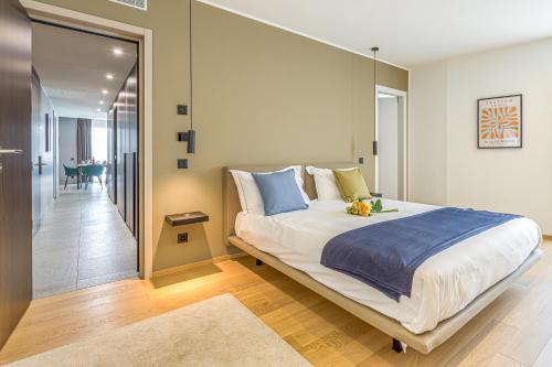 a bedroom with a large bed and a hallway at ICON H - Luxury Business Suite & Apartments in Lugano
