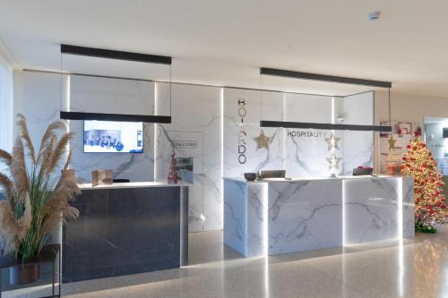 a lobby with a christmas tree in a room at Boiardo Hotel in Scandiano