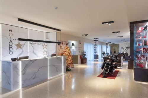 a store with a christmas tree and a motorcycle in the middle at Boiardo Hotel in Scandiano