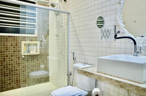 a bathroom with a sink and a toilet at Sobrado Fundição in Recife