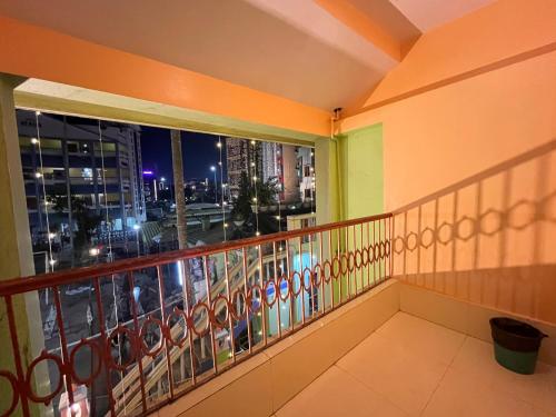 a balcony with a view of a city at night at Hotel Holiday Home in Digha