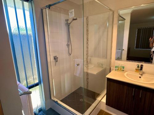 a bathroom with a shower and a sink at Quiet Busselton Retreat in Busselton