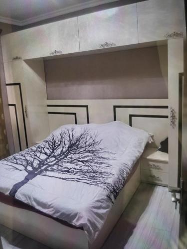 a bedroom with a bed with a tree on it at Argavand home in Yerevan