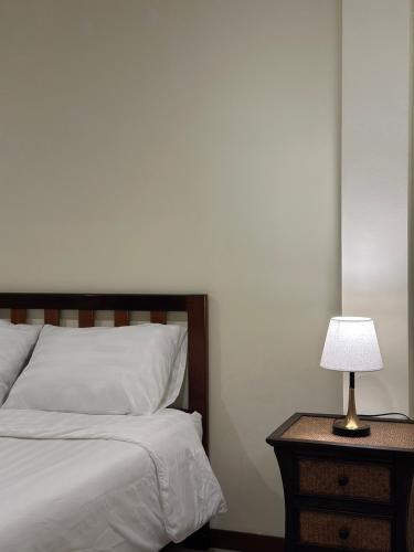 a bedroom with a bed and a table with a lamp at เวลาและนาที Wella&Natee in Chiang Khan