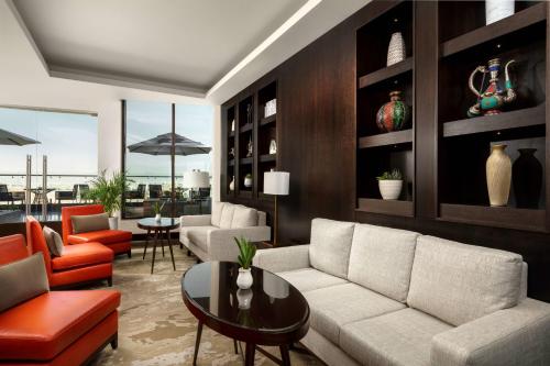 a living room with a couch and a table at JW Marriott Hotel Muscat in Muscat