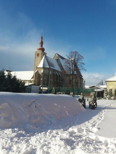 a snow ramp in front of a large church at Penzion Fako in Liptovský Mikuláš