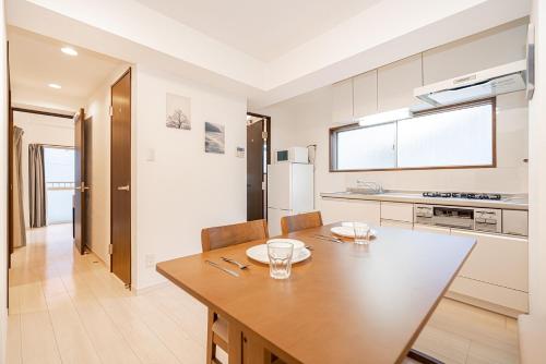 a kitchen with a wooden table and a dining room at Downtown Apartment/ SHIBUYA Station 10mins on foot in Tokyo