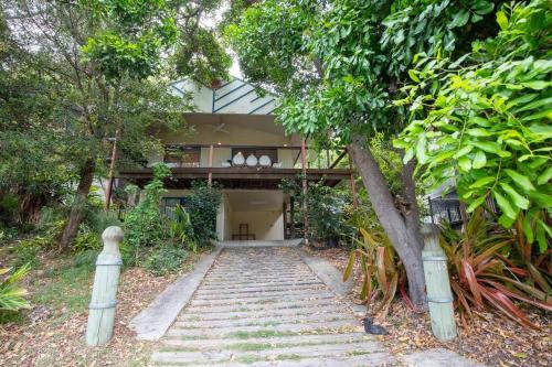 a house with stairs leading up to it at Tuckeroo + sleeps 10 + central in Point Lookout