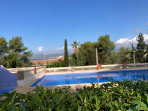 a large swimming pool with trees in the background at Appartement Vue Mer avec Piscine et WIFI in Salou