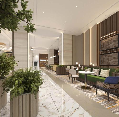 a lobby with chairs and tables and plants at Hilton Garden Inn Wuhan Hankou in Wuhan
