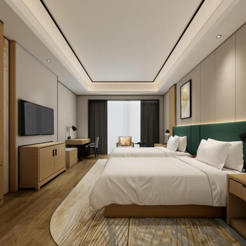 a hotel room with two beds and a flat screen tv at Hilton Garden Inn Wuhan Hankou in Wuhan