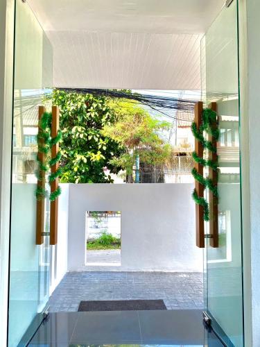 a glass door with a view of a courtyard at NANEE Phra Singh in Chiang Mai