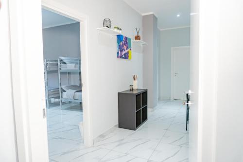 a white room with a mirror and a table at Hostel Partenope in Naples
