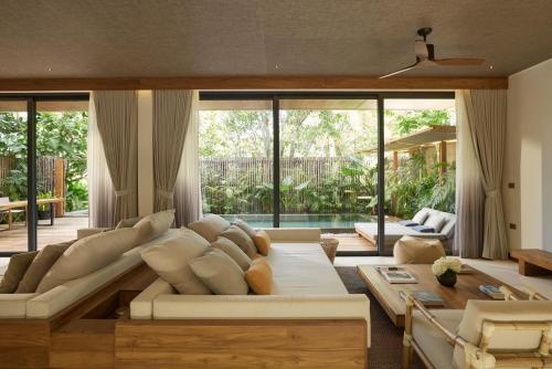 a living room with a couch and a table at The Retreat Koh Chang, an SLH Hotel in Ko Chang