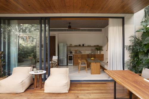 an open kitchen and dining room with sliding glass doors at The Retreat, Koh Chang in Ko Chang
