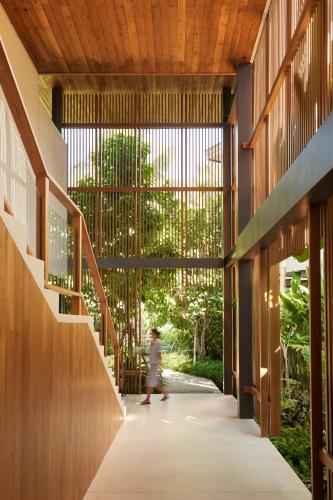 a hallway of a building with a person walking down it at The Retreat Koh Chang, an SLH Hotel in Ko Chang