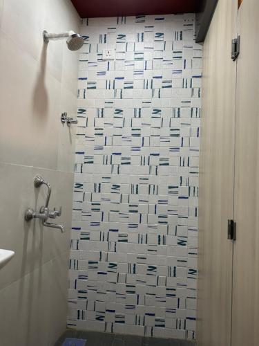 a bathroom with a shower with a shower curtain at ZEST STAYS - IIT in Mumbai
