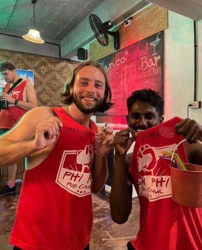 two men in red shirts posing for a picture at Blanco Central in Phi Phi Don