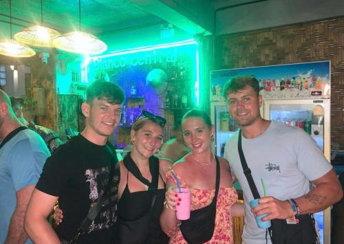 a group of people posing for a picture at a party at Blanco Central in Phi Phi Islands