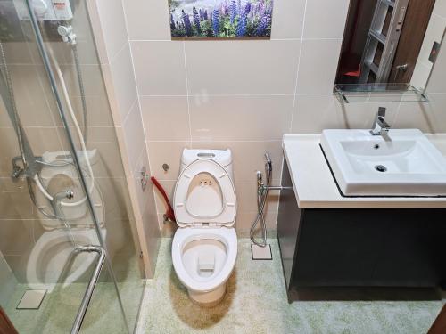 a bathroom with a toilet and a sink and a shower at Green Haven Homestay in Pasir Gudang