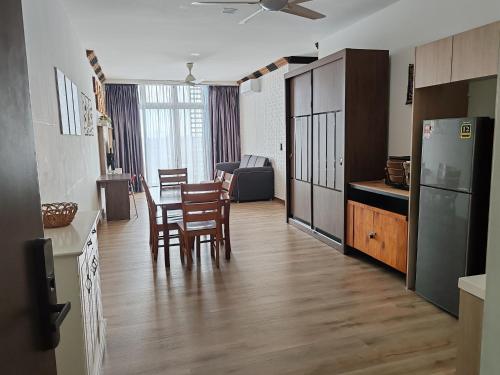 a kitchen and dining room with a table and chairs at Green Haven Homestay in Pasir Gudang
