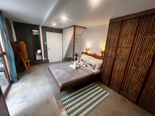 a bedroom with a bed in a room at Lugadia Bungalow in El Nido