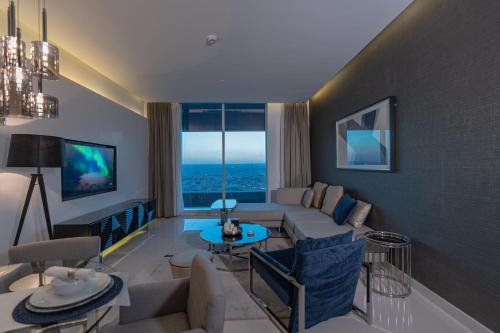 a living room with a couch and a table at DAMAC Riyadh - Luxury Apartments in Riyadh