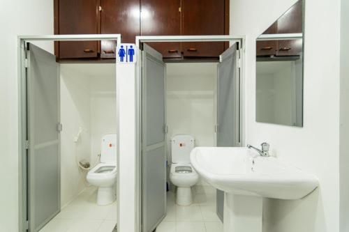 a bathroom with two toilets and a sink at Omega Villa in Galle