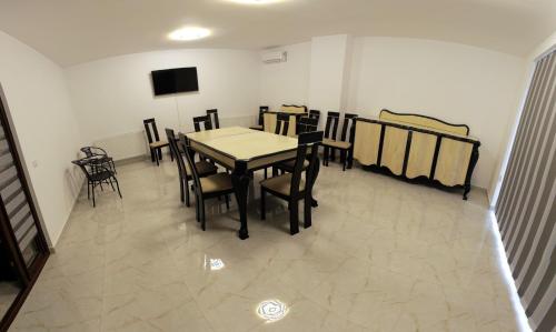 a dining room with a table and chairs at 2Family in Focşani