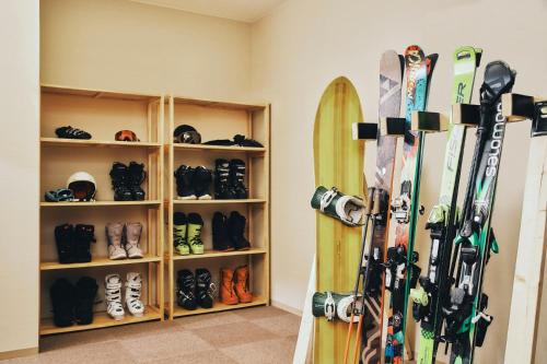 a room with a bunch of skis and snowboards at OMO5 Otaru by Hoshino Resorts in Otaru