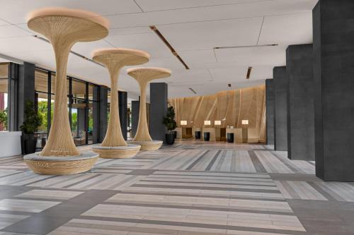 an empty lobby with columns in a building at Courtyard by Marriott Bangkok Suvarnabhumi Airport in Lat Krabang