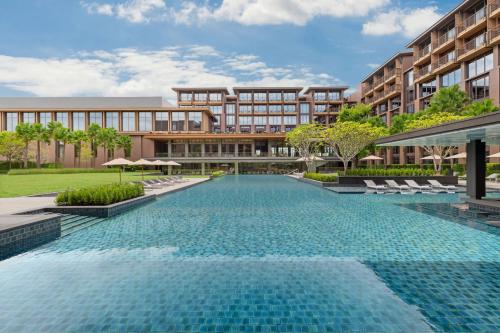 an image of a swimming pool in front of a building at Courtyard by Marriott Bangkok Suvarnabhumi Airport in Lat Krabang