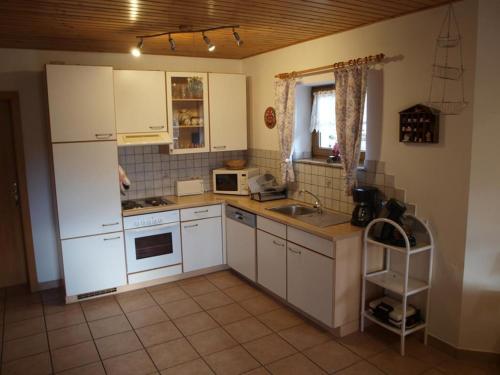 a kitchen with a white refrigerator and a sink at Haus Schober in Windischgarsten